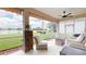 Serene screened patio with comfortable seating offers picturesque water views at 9800 Sago Point Dr, Seminole, FL 33777