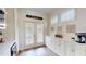 Sunroom features plantation shutters, door to outside and modern cabinetry with light countertops and decor at 9800 Sago Point Dr, Seminole, FL 33777