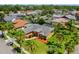 Beautiful aerial view of home surrounded by lush landscaping, mature trees, and a well-manicured lawn at 10228 Yellow Pine Way, Hudson, FL 34667