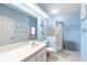Bathroom with a white vanity, shower, commode, and tiled floors at 10228 Yellow Pine Way, Hudson, FL 34667