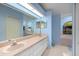 Bright bathroom boasts dual sinks, vanity, large mirror, and soaking tub at 10228 Yellow Pine Way, Hudson, FL 34667
