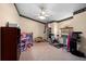 Flex room with workout equipment, dollhouse, and shelving at 10228 Yellow Pine Way, Hudson, FL 34667