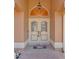 Close up of the home's double front door and brick entryway with a decorative welcome mat at 10228 Yellow Pine Way, Hudson, FL 34667
