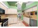 Bright kitchen with modern appliances, white cabinets, and an open view to the dining area at 10228 Yellow Pine Way, Hudson, FL 34667