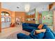 Stylish living room with a large sectional sofa, modern chandelier, and open floor plan at 10228 Yellow Pine Way, Hudson, FL 34667
