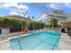 Screened in pool with plenty of room for entertaining, featuring tables, chairs, and lush plants at 10228 Yellow Pine Way, Hudson, FL 34667