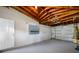 Spacious basement with painted floor, door to outside, and overhead door at 10599 111Th N Ave, Largo, FL 33773