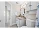 Bathroom with granite countertop, round mirror, and tiled floor at 10599 111Th N Ave, Largo, FL 33773