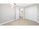 Bedroom featuring tile floor, sliding door closet, and fresh neutral paint at 10599 111Th N Ave, Largo, FL 33773