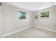 Bedroom with two windows, tile floor, baseboards, and fresh neutral paint at 10599 111Th N Ave, Largo, FL 33773