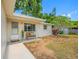 Charming home with a cozy front yard featuring a quaint bench, freshly painted exterior, and lovely landscaping at 10599 111Th N Ave, Largo, FL 33773
