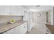 Well-lit kitchen featuring granite countertops, white cabinets and stainless steel appliances at 10599 111Th N Ave, Largo, FL 33773