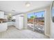 Eat in kitchen boasts ample white cabinetry, stainless appliances, and sliding doors for easy access to outdoor patio at 10599 111Th N Ave, Largo, FL 33773