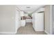 Clean kitchen showcasing white cabinets, granite countertops, tile flooring and appliances at 10599 111Th N Ave, Largo, FL 33773