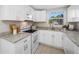 Cozy kitchen featuring modern white cabinetry, granite countertops, and stainless steel appliances at 10599 111Th N Ave, Largo, FL 33773