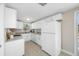 Bright kitchen featuring white cabinets, granite countertops, and tile flooring at 10599 111Th N Ave, Largo, FL 33773