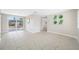 Bright living room featuring tile flooring, neutral walls, and a sliding glass door to the outdoor patio at 10599 111Th N Ave, Largo, FL 33773