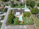 Aerial view of a house and the surrounding neighborhood, showing the lawn and pool at 10611 131St St, Largo, FL 33774