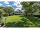 Spacious backyard featuring lush green lawn, mature trees, and well-maintained landscaping at 10611 131St St, Largo, FL 33774