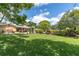 Expansive backyard featuring well-manicured lawn, mature trees, and a private pool area at 10611 131St St, Largo, FL 33774
