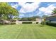 Expansive backyard featuring lush lawn, storage sheds, and ample space for outdoor activities at 10611 131St St, Largo, FL 33774