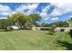 Expansive backyard with well-maintained lawn, mature trees, and a charming shed for outdoor storage and activities at 10611 131St St, Largo, FL 33774