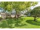 Expansive backyard featuring mature trees, a well-maintained lawn, and multiple storage sheds, offering ample space at 10611 131St St, Largo, FL 33774