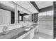 Bathroom featuring a wide mirror, long countertop, stylish sink, and bright natural light at 10611 131St St, Largo, FL 33774