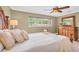 Bedroom with a view of the large window, white bedding, tan walls, and coordinated decor at 10611 131St St, Largo, FL 33774