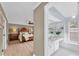 View of the bedroom and adjoining bathroom showing neutral tones, wooden furniture, and a bright, airy space at 10611 131St St, Largo, FL 33774