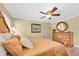 Bedroom with an ornate mirror sitting atop a dresser with light beige colors and modern fixtures at 10611 131St St, Largo, FL 33774