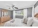 Bedroom featuring a full bed, large window with blinds, and a dresser with a decorative mirror at 10611 131St St, Largo, FL 33774