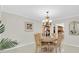 Dining room showcasing an elegant chandelier, round table with seating for four, and tile flooring at 10611 131St St, Largo, FL 33774