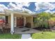 Inviting front entrance with a covered porch, stone facade and attractive landscaping at 10611 131St St, Largo, FL 33774