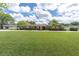 Charming single-story home featuring a huge front lawn, mature trees and attractive landscaping at 10611 131St St, Largo, FL 33774