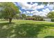 Spacious front yard with mature trees and lush lawn leading to a well-maintained single-Gathering home at 10611 131St St, Largo, FL 33774
