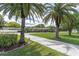 Palm trees accent the circular driveway to this single Gathering home at 10611 131St St, Largo, FL 33774