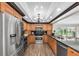 Well-appointed kitchen with stainless steel appliances, wood cabinetry, and dark granite countertops at 10611 131St St, Largo, FL 33774