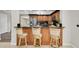 Kitchen bar featuring dark countertops, wood cabinetry, and seating for casual dining at 10611 131St St, Largo, FL 33774
