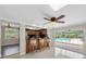 Kitchen bar area with wood cabinets, barstool seating, and a view of the outdoor pool at 10611 131St St, Largo, FL 33774