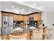 Kitchen bar showcasing dark countertops, wooden cabinets, and barstool seating at 10611 131St St, Largo, FL 33774