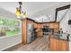 Updated kitchen with stainless steel appliances, wood cabinets, and a view of the backyard at 10611 131St St, Largo, FL 33774