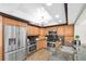 Modern kitchen with stainless steel appliances, wood cabinetry, and dark countertops at 10611 131St St, Largo, FL 33774