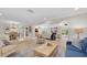 Spacious living room featuring an open layout, neutral decor, wood floors, and plenty of natural light at 10611 131St St, Largo, FL 33774