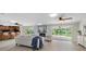 Open living space featuring a fireplace, connection to the kitchen, and views of the backyard pool at 10611 131St St, Largo, FL 33774