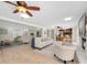 Open-concept living room with fireplace, comfortable seating, and a view of the kitchen and dining area at 10611 131St St, Largo, FL 33774