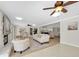 The living room offers a cozy seating arrangement, ceiling fans, and natural light at 10611 131St St, Largo, FL 33774