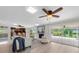 The bright living room features a stone fireplace, neutral decor, and access to a patio area at 10611 131St St, Largo, FL 33774