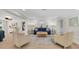 Comfortable living room with a blue sofa, neutral armchairs, and an open archway to the dining area at 10611 131St St, Largo, FL 33774