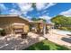 Paver patio featuring an outdoor table set, porch swing and fire pit with backyard pool at 10611 131St St, Largo, FL 33774